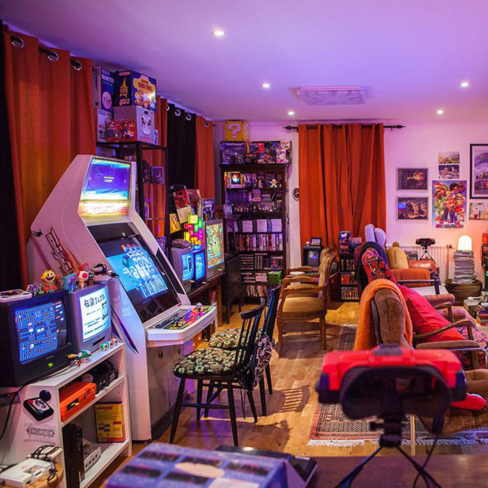 Colorful vintage game room with arcade machines, retro consoles, and cozy seating creating the perfect gaming cave atmosphere. Colorful vintage game room with arcade machines, retro consoles, and cozy seating creating the perfect gaming cave atmosphere.
