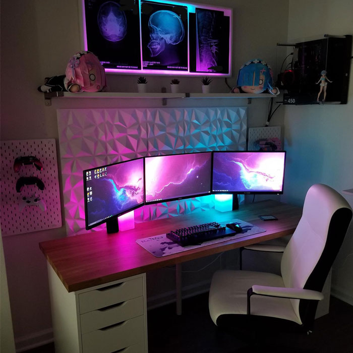 Small minimalistic game room with triple monitors, RGB lighting, and a clean wooden desk setup for immersive gaming. Small minimalistic game room with triple monitors, RGB lighting, and a clean wooden desk setup for immersive gaming.