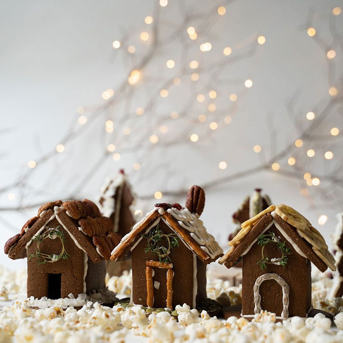 Gingerbread houses with nuts and bananas on the roof.