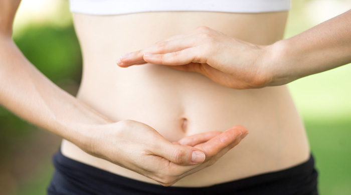 Woman's hands and slim belly