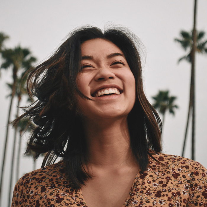 Woman brown floral dress smiling 