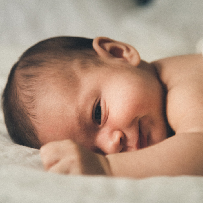 Newborn lying on his belly 