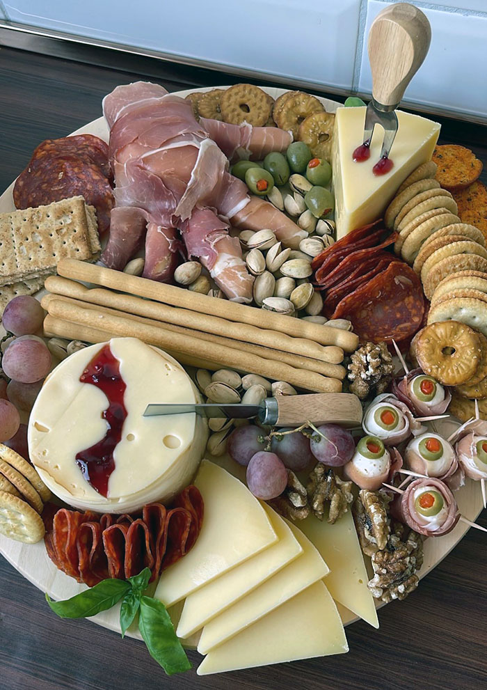 Halloween Charcuterie With Prosciutto And Goat Cheese Hand, Mozzarella And Olive Eyeballs, Jam And Smoked Gouda Bat