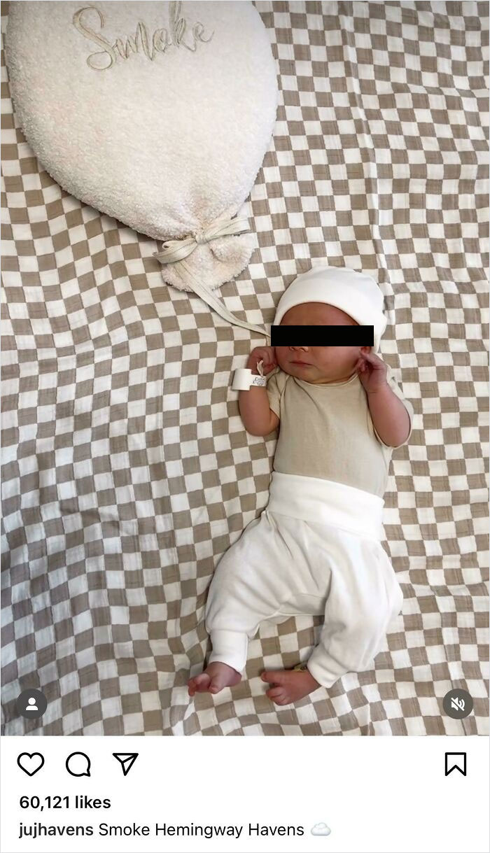 Cute baby wrapped in white clothing, lying on a checkered blanket. Balloon shape with "Smoke" written nearby.