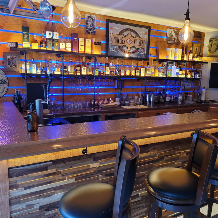 Bright home bar with various glasses and liquor bottles, showcasing stylish home bar ideas for a happy hour setting. Bright home bar with various glasses and liquor bottles, showcasing stylish home bar ideas for a happy hour setting.