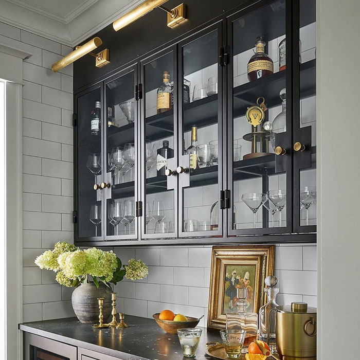 Classy home bar with gold trim, glass cabinets, and elegant drinkware for a stylish happy hour setting. Classy home bar with gold trim, glass cabinets, and elegant drinkware for a stylish happy hour setting.