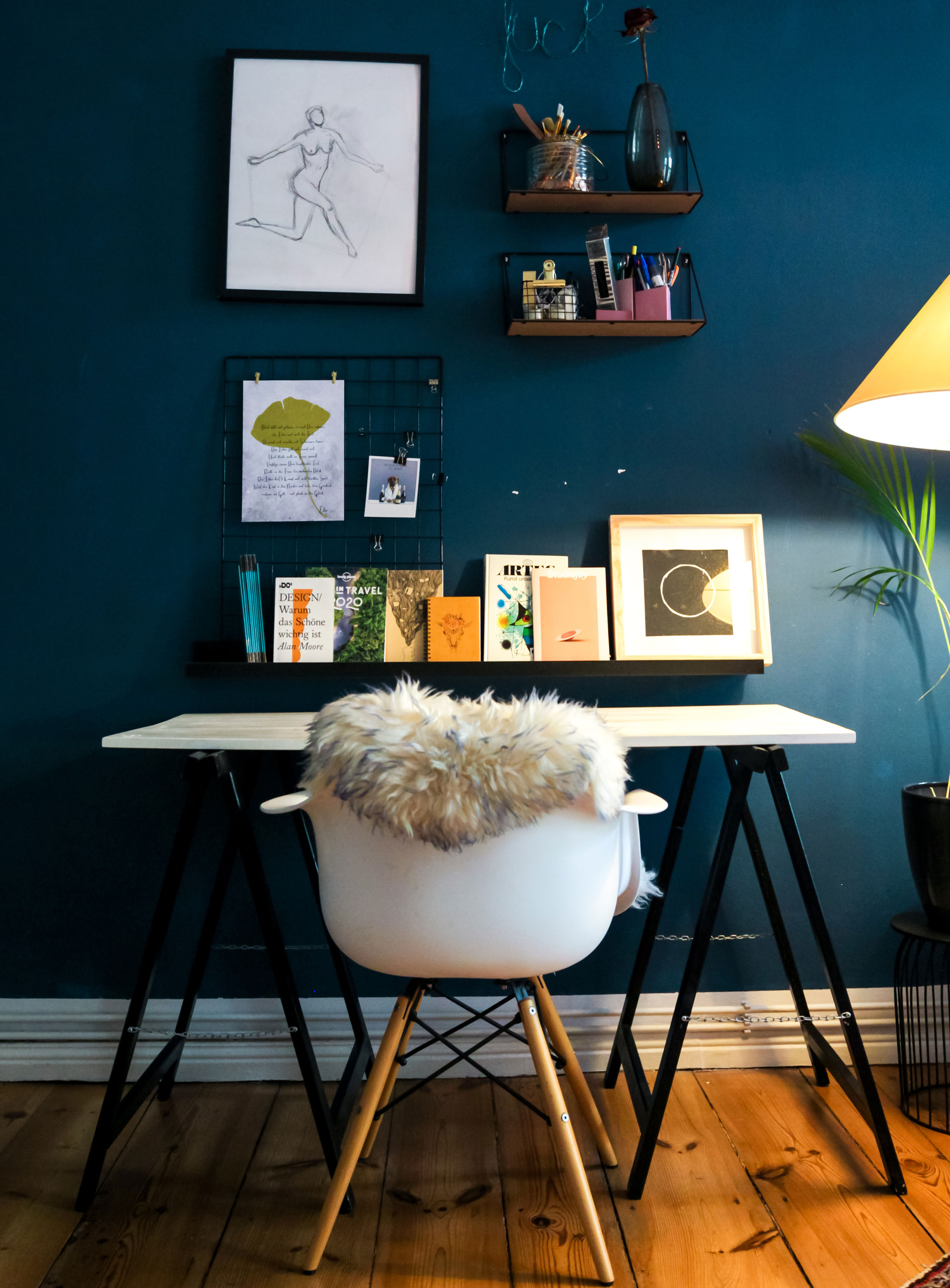 White fur textile draped over a chair in a stylish home office showcasing modern home office ideas.