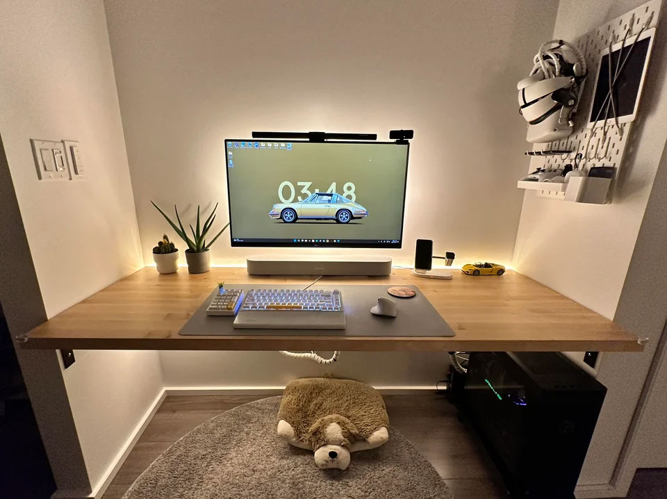 Minimalist wall-mounted desk with ambient lighting, computer setup, and organized accessories for home office ideas boosting productivity.