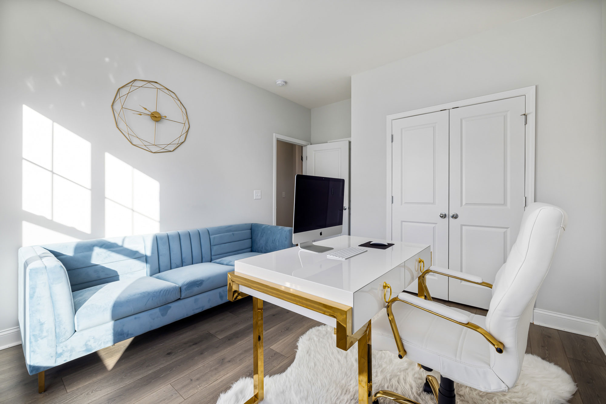 Modern home office setup with a white desk and chair featuring golden details for productive work ideas