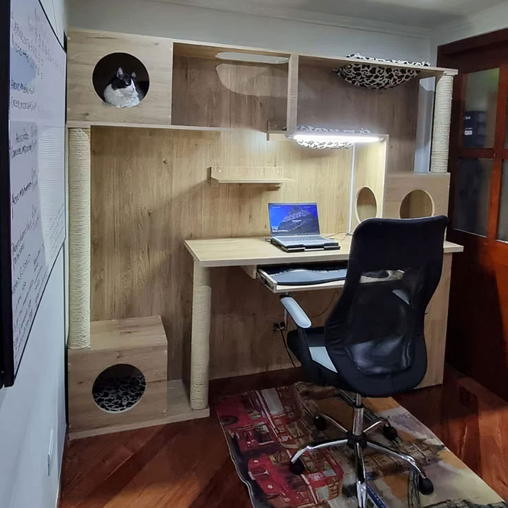 Home office ideas featuring a wooden cat house integrated around a productive work desk and chair setup.