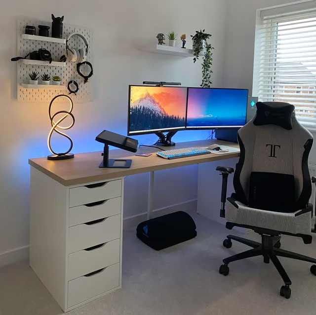 Wooden desk with dual monitors, modern LED lamp, ergonomic chair, and minimal decor for home office ideas.