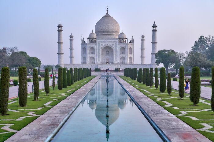 Taj Mahal in India with its reflection in water, illustrating cultural landmarks related to countries and wealth perceptions.