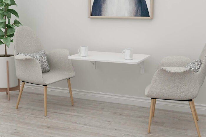 gray floating desk with cups and chairs
