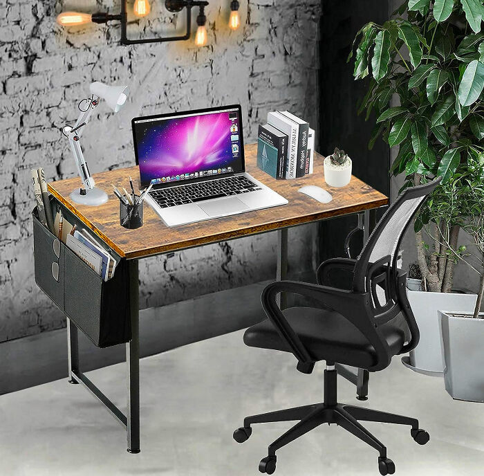 wooden desk with computer phone and books