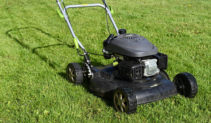 Black lawn mover on the grass