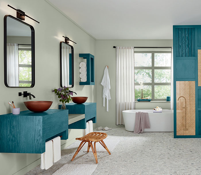 Bright bathroom featuring Bay Blue wood stain colors on vanities and cabinetry with natural light and modern design.