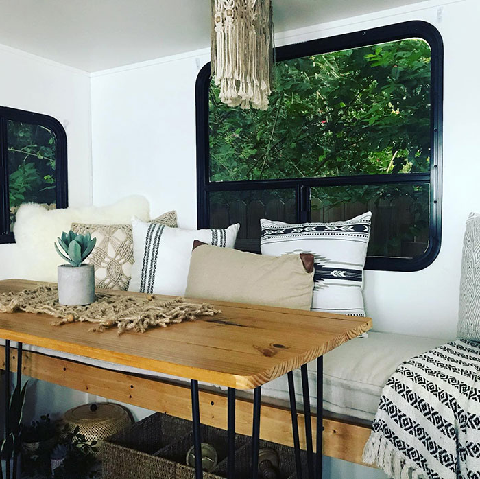 Early American style wooden table with Minwax stain colors in a cozy room featuring decorative pillows and natural light.