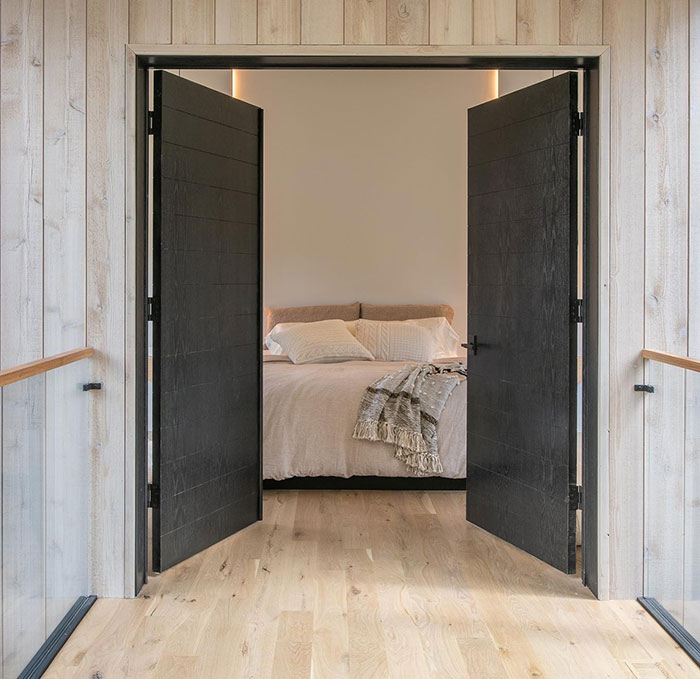 True black wood stained double doors leading to a cozy bedroom showcasing Minwax stain colors.