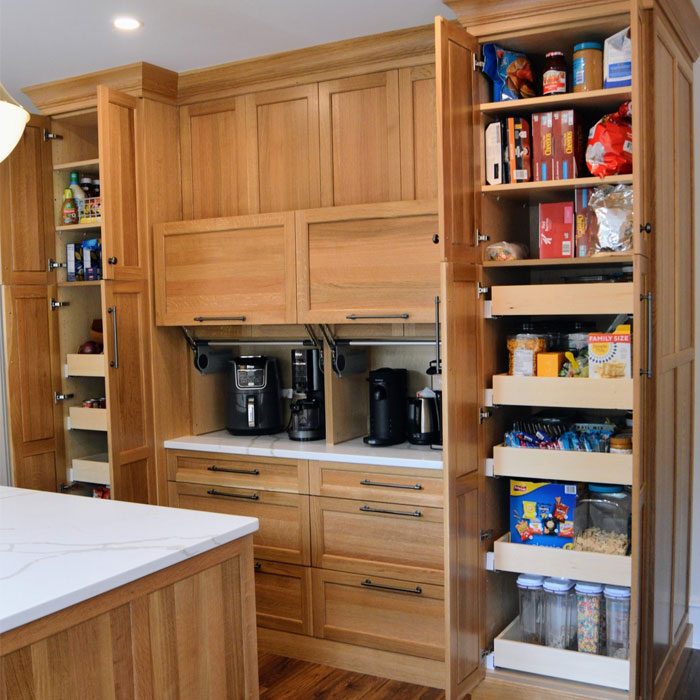 Smart storage room in a brown kitchen featuring modern kitchen designs with organized pantry shelves and wooden cabinetry.