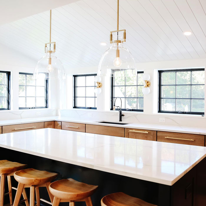 Spacious modern kitchen design with a minimalist no cabinet layout, featuring a large island and bright natural lighting.