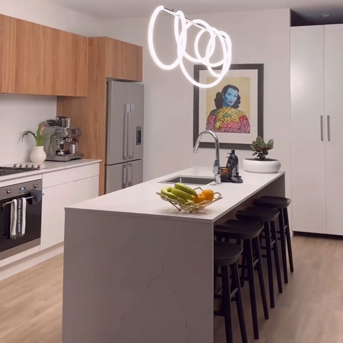 Modern kitchen design featuring a sleek island, statement pendant light, and wood-accented cabinets for a timeless look.