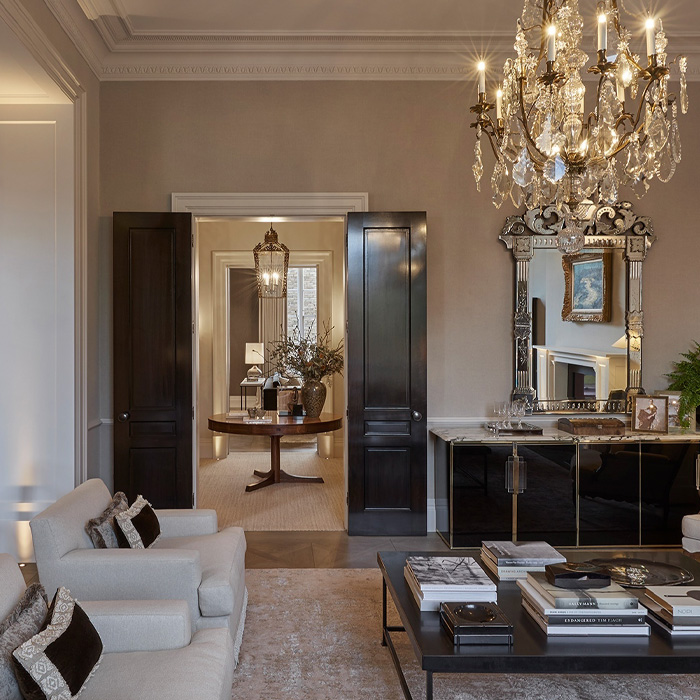 Elegant living room featuring an ornate golden chandelier and classic old money interior design elements. Elegant living room featuring an ornate golden chandelier and classic old money interior design elements.