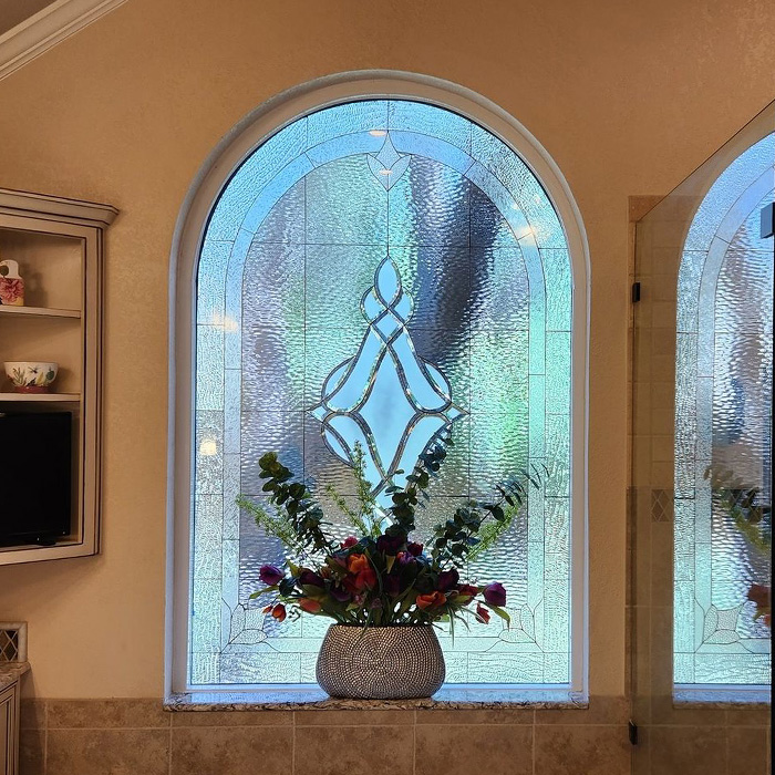 Stained glass window with an elegant vase of flowers exemplifying old money interior design style and luxury living. Stained glass window with an elegant vase of flowers exemplifying old money interior design style and luxury living.