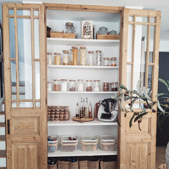 Pantry with opened wooden door 