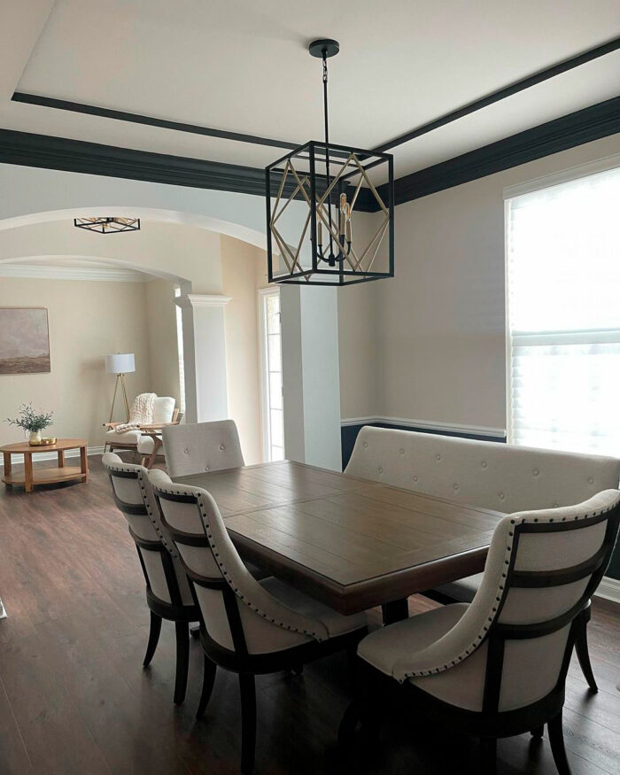 Dining room with Sherwin-Williams paint colors featuring soft neutral walls and a large wooden table with upholstered chairs