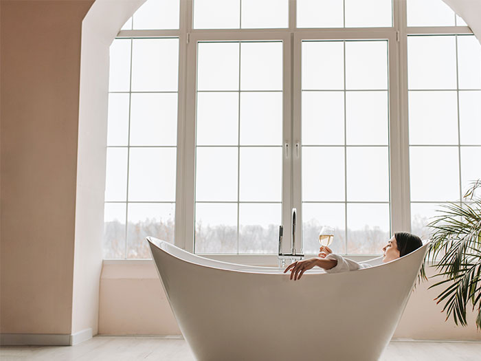 Woman lying on white bathtub Woman lying on white bathtub