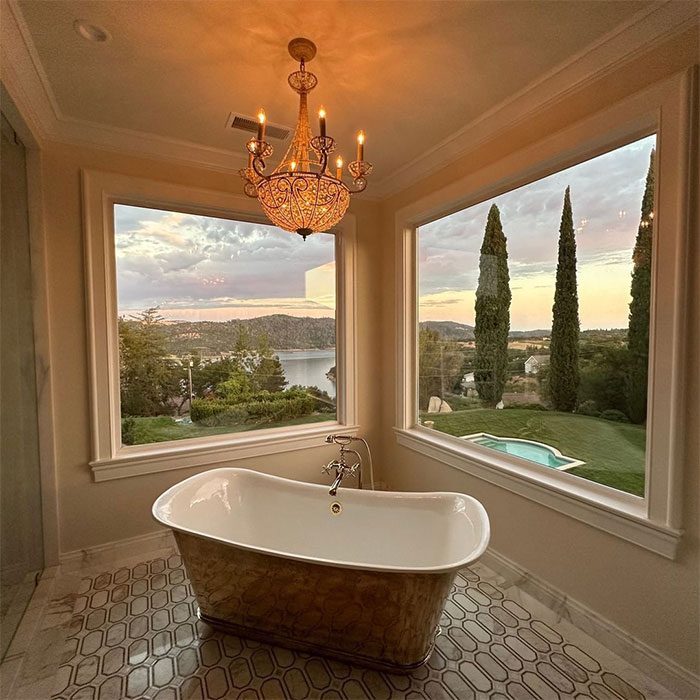 bathroom with iron soak tub near windows bathroom with iron soak tub near windows