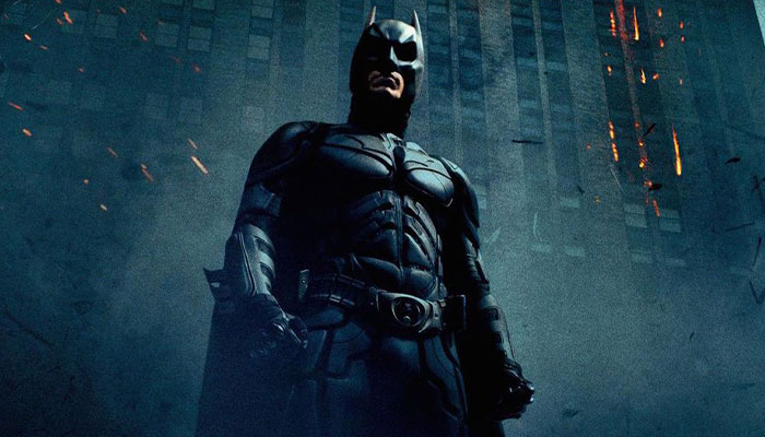 Batman standing heroically in front of a dark cityscape, referencing mysterious posts by Matthew Perry.