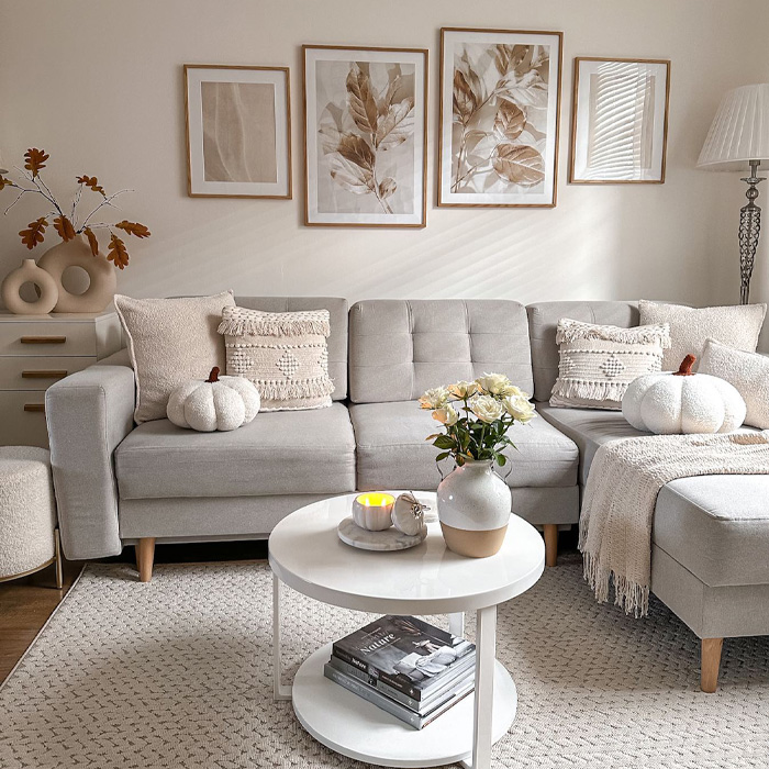 Grey couch with cushions and warm color decor featuring flowers and cozy accents in a stylish living room setting Grey couch with cushions and warm color decor featuring flowers and cozy accents in a stylish living room setting