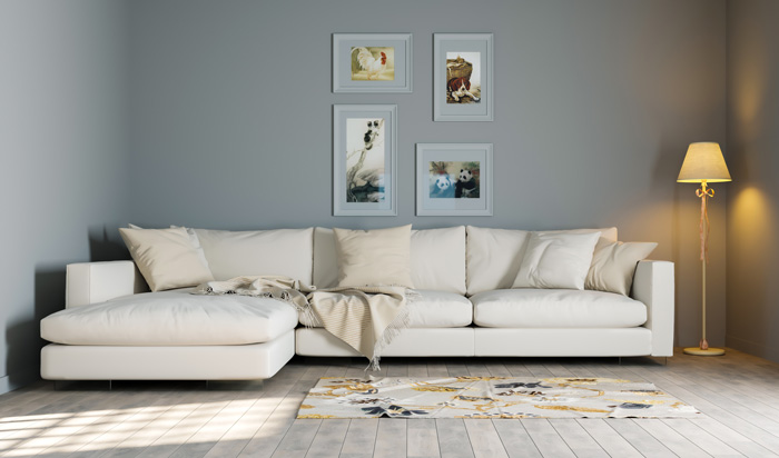 White couch with pillows in a living room featuring warm colors, a lamp, and framed wall art for cozy decor ideas. White couch with pillows in a living room featuring warm colors, a lamp, and framed wall art for cozy decor ideas.