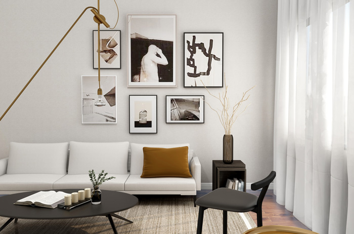 White couch with a warm-colored pillow next to a black coffee table and chair in a modern living room decor. White couch with a warm-colored pillow next to a black coffee table and chair in a modern living room decor.