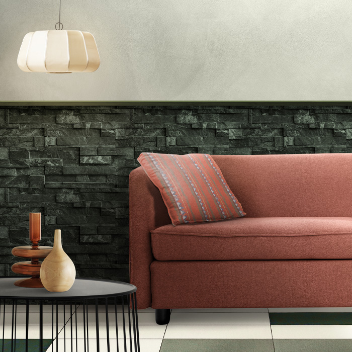 Pink couch with patterned cushion beside modern coffee table showcasing warm colors decor ideas in living room. Pink couch with patterned cushion beside modern coffee table showcasing warm colors decor ideas in living room.