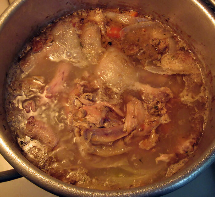 Boiling chicken pieces in a pot, representing cooking fails shared by users in an online community forum.