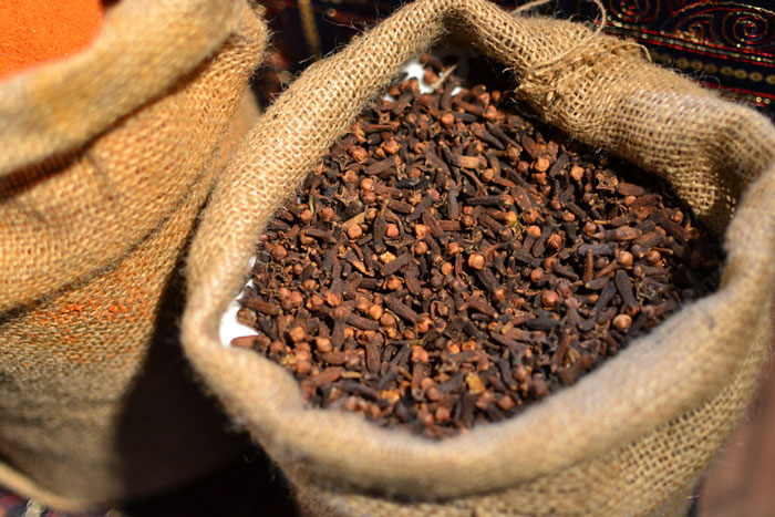 Close-up of a burlap sack filled with whole cloves, related to cooking fails shared in an online community forum.