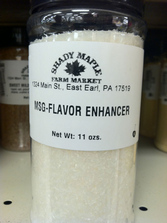 Clear plastic container of MSG flavor enhancer on a shelf, related to cooking fails shared in an online forum.