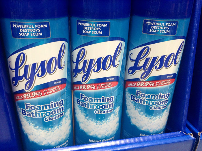 Bottles of Lysol foaming bathroom cleaner on a store shelf showing powerful foam and cleaning action.