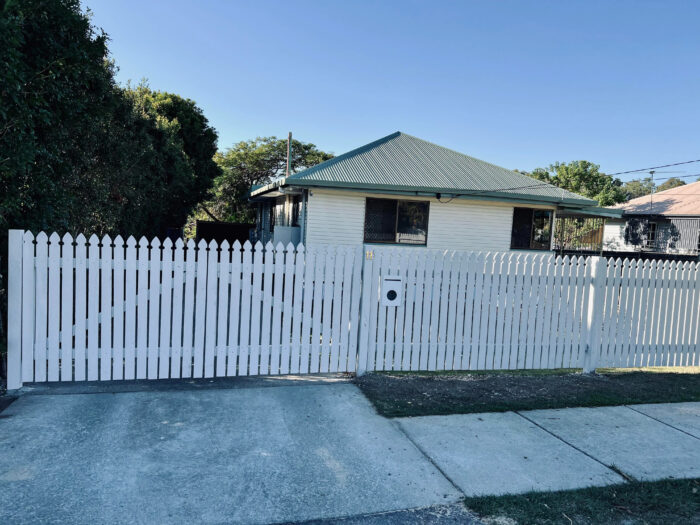 Closely spaced white picked fence Closely spaced white picked fence