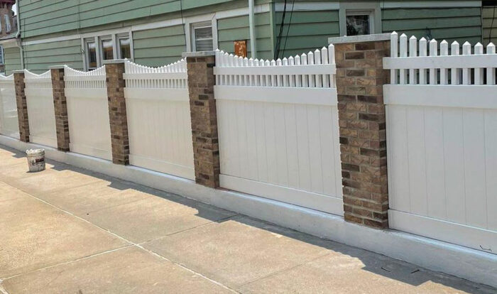 A wave-shaped PVC white picket fence A wave-shaped PVC white picket fence
