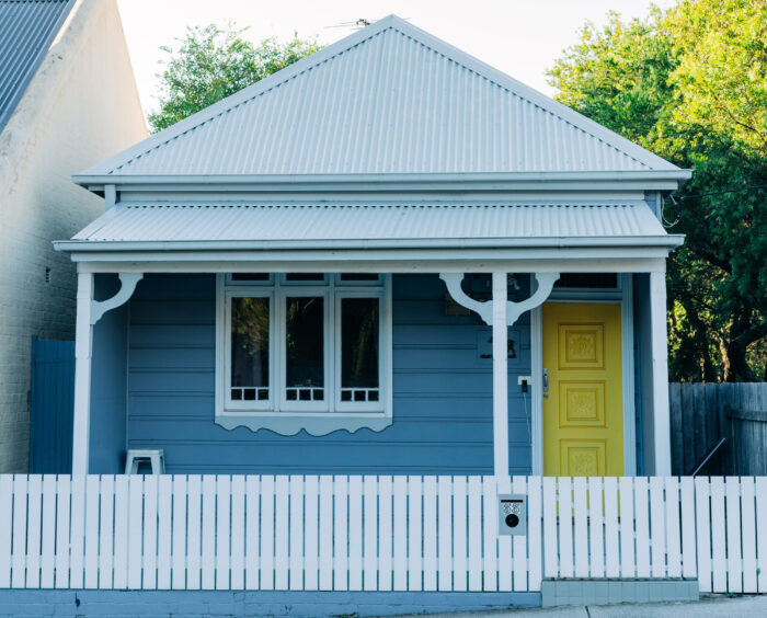 Blue house with a white picket fence Blue house with a white picket fence