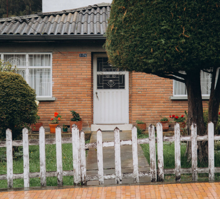 A house with a dirty old wooden fence A house with a dirty old wooden fence