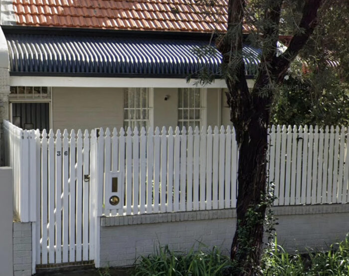 Closely spaced panels on a white picket fence Closely spaced panels on a white picket fence