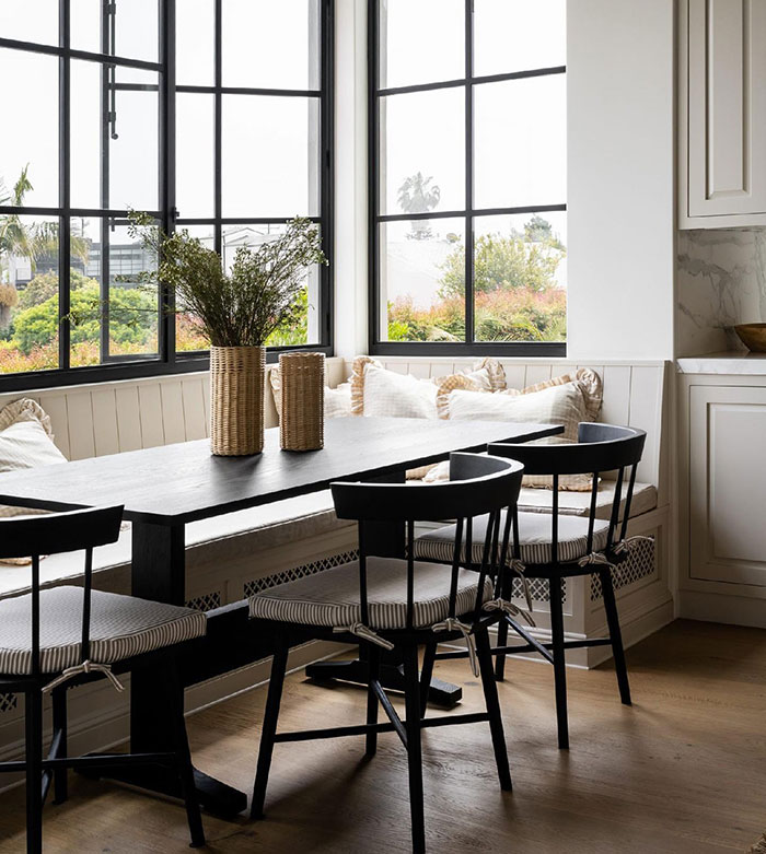 Black and white window seat with table and chairs 