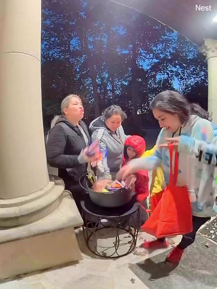 Family taking all Halloween candy from bowl on porch in the evening during trick or treat activities. Family taking all Halloween candy from bowl on porch in the evening during trick or treat activities.