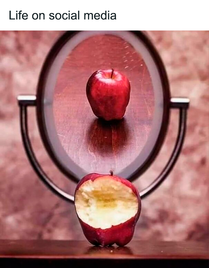 Bitten apple reflecting as whole in mirror, illustrating what’s wrong with society and life on social media concept.