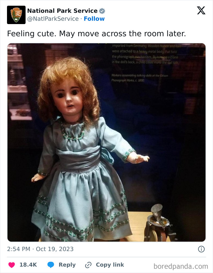 Antique doll in a blue dress displayed in a museum, featured in National Park Service social media post.