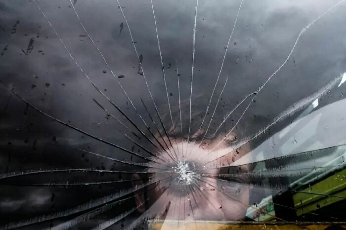 A Photograph Of A Man Behind A Crooked Glass